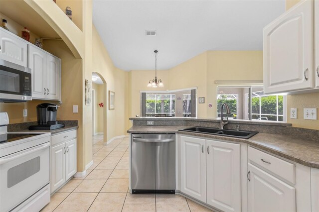 11 White Oak Ln, Palm Coast, FL 32164 - kitchen featuring appliances with stainless steel finishes, a sink, white cabinetry, dark countertops, and a chandelier