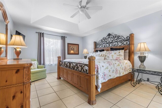11 White Oak Ln, Palm Coast, FL 32164 - bedroom with a tray ceiling, light tile patterned flooring, and a ceiling fan