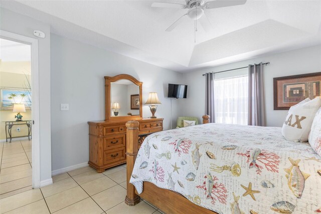 11 White Oak Ln, Palm Coast, FL 32164 - bedroom featuring light tile patterned flooring, ceiling fan, baseboards, and a tray ceiling