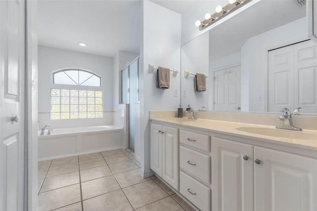 11 White Oak Ln, Palm Coast, FL 32164 - full bath with tile patterned flooring, double vanity, a shower stall, and a garden tub