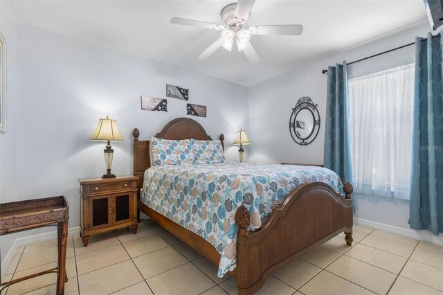 11 White Oak Ln, Palm Coast, FL 32164 - tiled bedroom with baseboards and ceiling fan