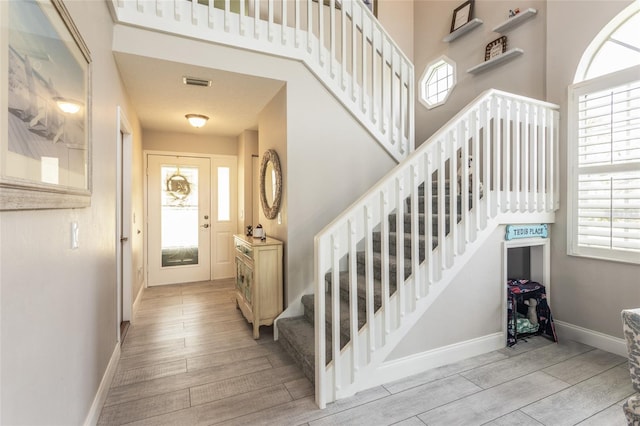 7 Bristol Dr, Palm Coast, FL 32137 - entryway with stairs, wood finished floors, and plenty of natural light