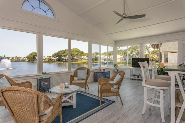 7 Bristol Dr, Palm Coast, FL 32137 - sunroom / solarium featuring wood finished floors, a wood stove, and a deck with water view