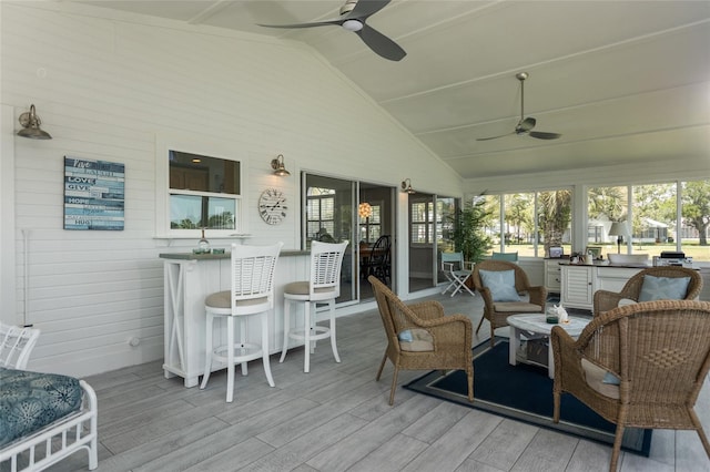 7 Bristol Dr, Palm Coast, FL 32137 - sunroom / solarium featuring ceiling fan, lofted ceiling, wood finished floors, a wooden deck, and wooden walls