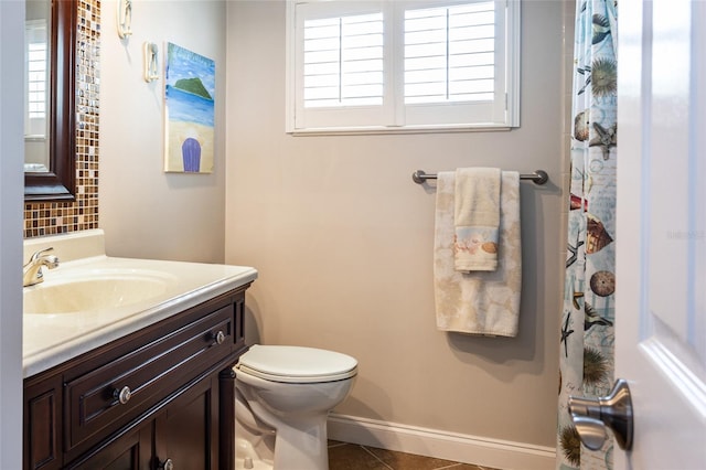 7 Bristol Dr, Palm Coast, FL 32137 - full bathroom with tile patterned flooring, backsplash, vanity, baseboards, and toilet
