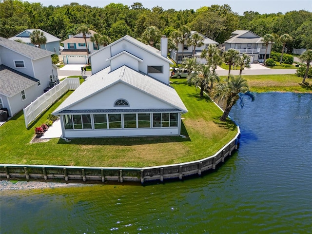 7 Bristol Dr, Palm Coast, FL 32137 - rear view of property with a water view, a chimney, a residential view, and a shingled roof