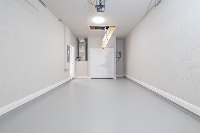 45 Providence Ln, Palm Coast, FL 32164 - garage with a garage door opener, concrete block wall, baseboards, and heating unit