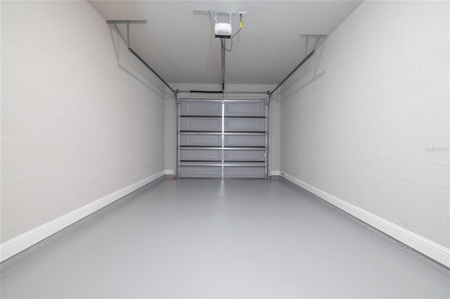 45 Providence Ln, Palm Coast, FL 32164 - garage featuring a garage door opener and baseboards