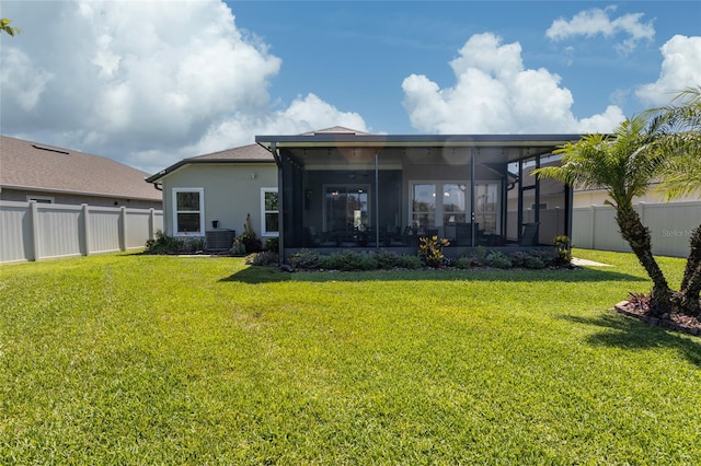 115 N Coopers Hawk Way, Palm Coast, FL 32164 - rear view of house with a sunroom, central AC, and stucco siding