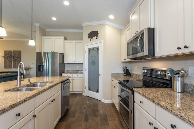 115 N Coopers Hawk Way, Palm Coast, FL 32164 - kitchen featuring stainless steel appliances, a sink, ornamental molding, dark wood-style flooring, and white cabinets