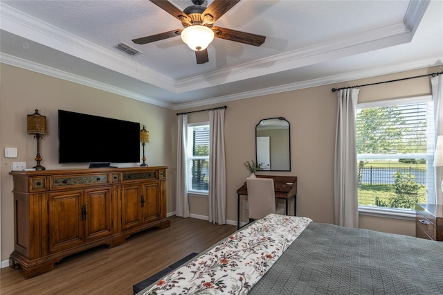 115 N Coopers Hawk Way, Palm Coast, FL 32164 - bedroom featuring a raised ceiling, wood finished floors, ornamental molding, a ceiling fan, and baseboards