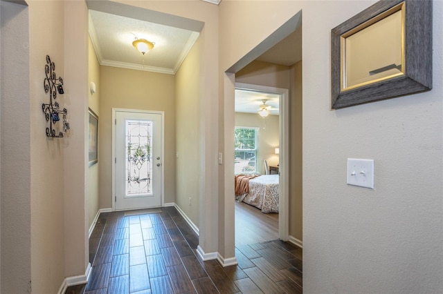 115 N Coopers Hawk Way, Palm Coast, FL 32164 - entrance foyer with wood tiled floors, baseboards, crown molding, and a ceiling fan
