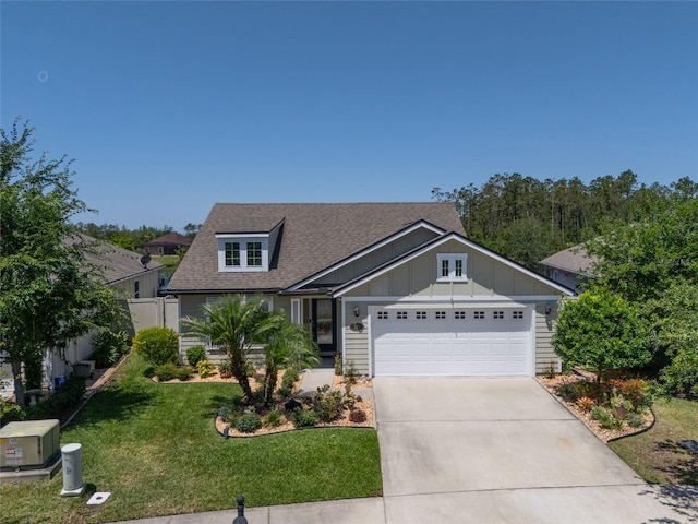 115 N Coopers Hawk Way, Palm Coast, FL 32164 - view of front facade with roof with shingles, board and batten siding, an attached garage, and driveway