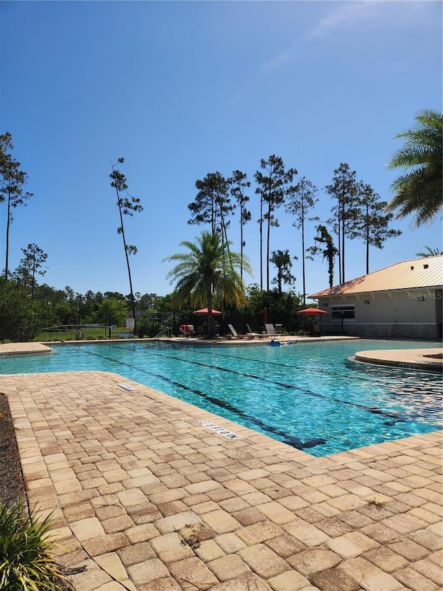 115 N Coopers Hawk Way, Palm Coast, FL 32164 - community pool featuring a patio area