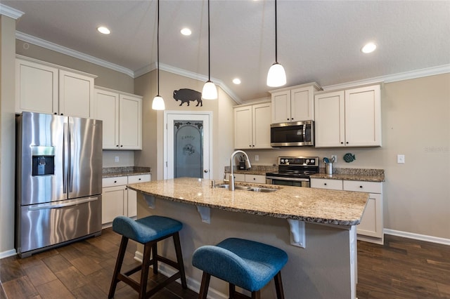 115 N Coopers Hawk Way, Palm Coast, FL 32164 - kitchen with stainless steel appliances, a sink, crown molding, dark wood-type flooring, and a kitchen breakfast bar
