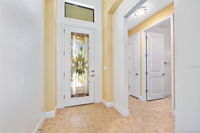 27 Bay Ct, Ormond Beach, FL 32174 - entryway with light tile patterned flooring and baseboards