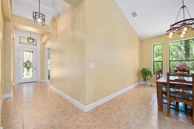 27 Bay Ct, Ormond Beach, FL 32174 - foyer featuring high vaulted ceiling, a chandelier, light tile patterned floors, and baseboards