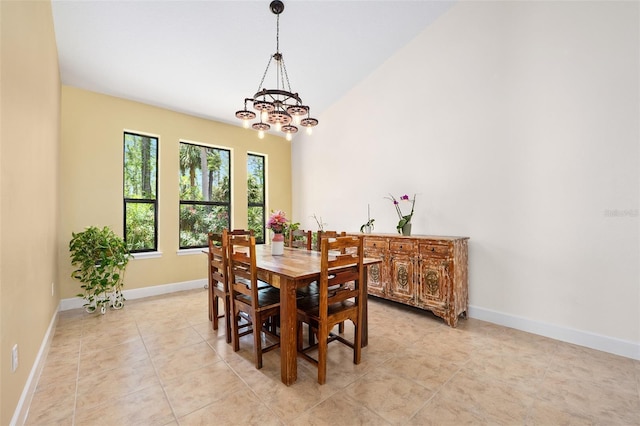 27 Bay Ct, Ormond Beach, FL 32174 - dining area featuring baseboards, a chandelier, light tile patterned floors, and vaulted ceiling