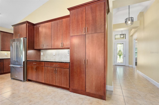 27 Bay Ct, Ormond Beach, FL 32174 - kitchen featuring freestanding refrigerator, light tile patterned floors, a high ceiling, tasteful backsplash, and baseboards