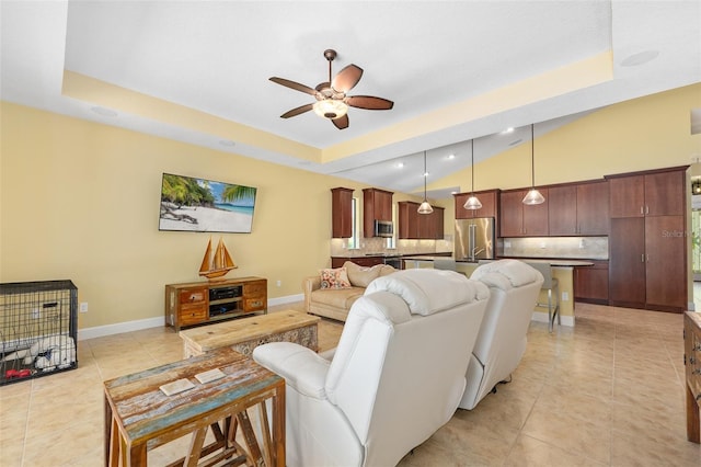 27 Bay Ct, Ormond Beach, FL 32174 - living room with ceiling fan, light tile patterned floors, baseboards, a tray ceiling, and vaulted ceiling