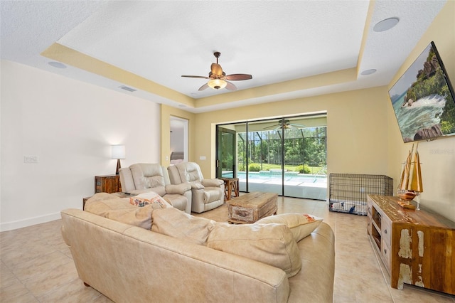 27 Bay Ct, Ormond Beach, FL 32174 - living area featuring a tray ceiling, a ceiling fan, and light tile patterned flooring