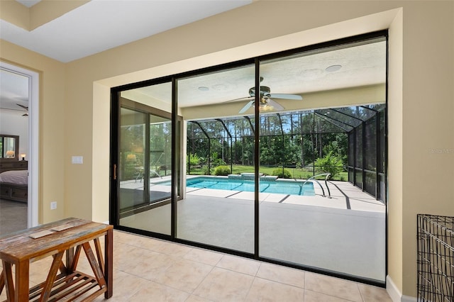 27 Bay Ct, Ormond Beach, FL 32174 - doorway to outside with ceiling fan, a sunroom, healthy amount of natural light, and tile patterned floors