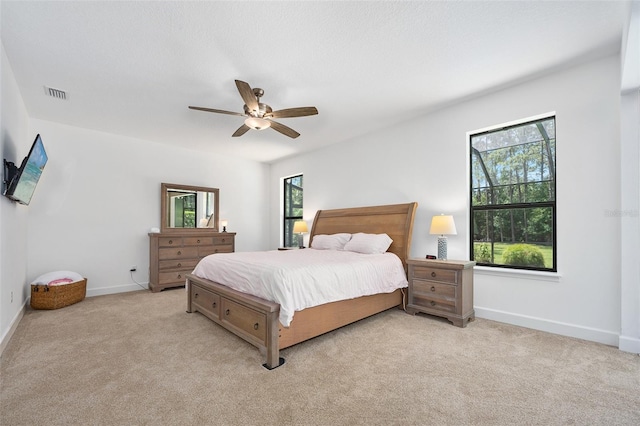 27 Bay Ct, Ormond Beach, FL 32174 - bedroom featuring light colored carpet, baseboards, and ceiling fan