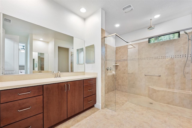 27 Bay Ct, Ormond Beach, FL 32174 - bathroom featuring a tile shower, vanity, tile patterned floors, and recessed lighting