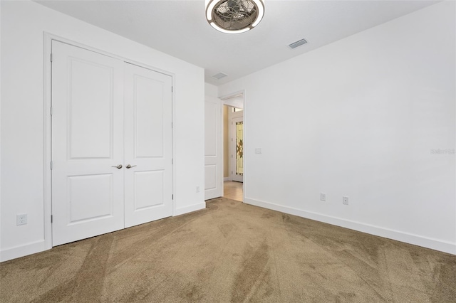 27 Bay Ct, Ormond Beach, FL 32174 - unfurnished bedroom with carpet flooring, baseboards, and a closet