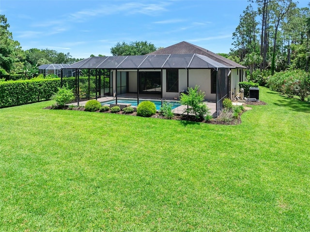 27 Bay Ct, Ormond Beach, FL 32174 - back of property featuring a lawn, an outdoor pool, and glass enclosure