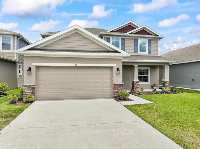 40 Oakleaf Way, Palm Coast, FL 32137 - craftsman inspired home with stone siding, stucco siding, a front yard, and concrete driveway
