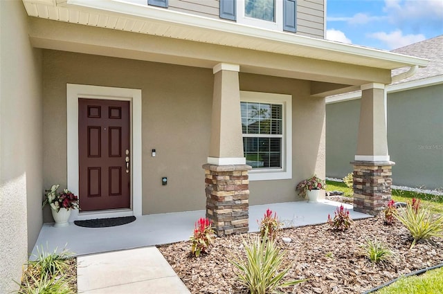 40 Oakleaf Way, Palm Coast, FL 32137 - property entrance with stucco siding and a porch