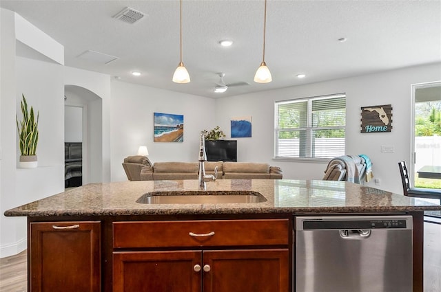 40 Oakleaf Way, Palm Coast, FL 32137 - kitchen featuring stainless steel dishwasher, a sink, arched walkways, dark stone counters, and recessed lighting