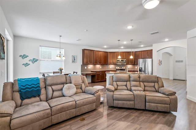 40 Oakleaf Way, Palm Coast, FL 32137 - living area featuring arched walkways, light wood-style flooring, and recessed lighting