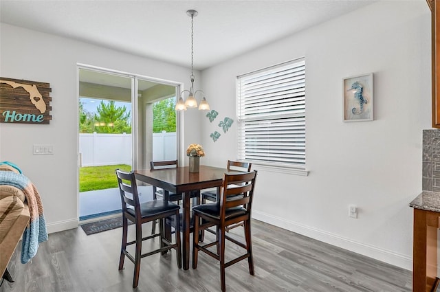 40 Oakleaf Way, Palm Coast, FL 32137 - dining space with wood finished floors, a chandelier, and baseboards