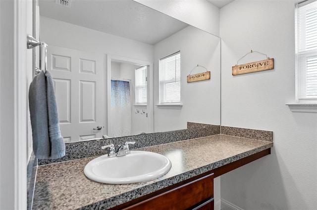 40 Oakleaf Way, Palm Coast, FL 32137 - bathroom featuring vanity and plenty of natural light