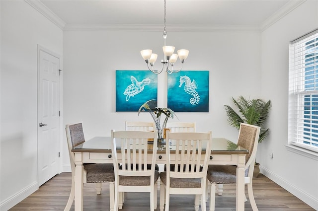 40 Oakleaf Way, Palm Coast, FL 32137 - dining space featuring wood finished floors, a chandelier, ornamental molding, and baseboards