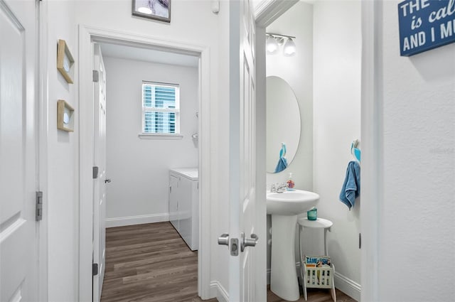 40 Oakleaf Way, Palm Coast, FL 32137 - bathroom with washer and clothes dryer, baseboards, wood finished floors, and a sink