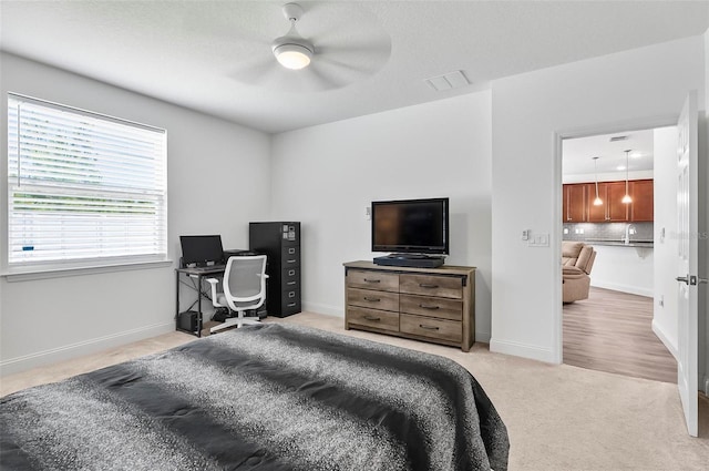 40 Oakleaf Way, Palm Coast, FL 32137 - bedroom featuring an office area, light colored carpet, baseboards, and a ceiling fan