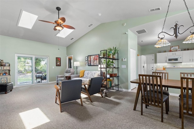 11 Roxboro Dr, Palm Coast, FL 32164 - dining space with a skylight, light colored carpet, a ceiling fan, baseboards, and high vaulted ceiling