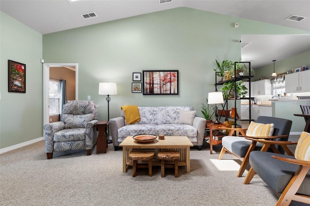 11 Roxboro Dr, Palm Coast, FL 32164 - living room with vaulted ceiling, light carpet, and baseboards