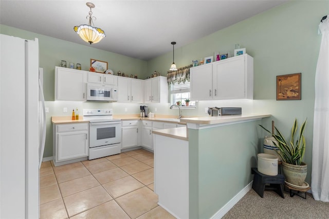11 Roxboro Dr, Palm Coast, FL 32164 - kitchen featuring white appliances, white cabinetry, hanging light fixtures, and light countertops