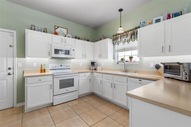 11 Roxboro Dr, Palm Coast, FL 32164 - kitchen featuring white appliances, a sink, white cabinets, and light tile patterned flooring