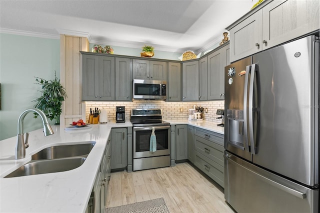 80 Surfview Dr Unit 721, Palm Coast, FL 32137 - kitchen with stainless steel appliances, ornamental molding, tasteful backsplash, light wood-type flooring, and gray cabinetry