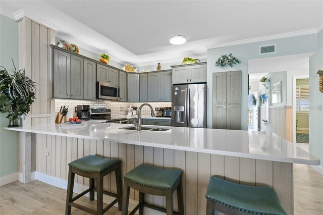 80 Surfview Dr Unit 721, Palm Coast, FL 32137 - kitchen featuring stainless steel appliances, tasteful backsplash, a peninsula, a breakfast bar, and light countertops