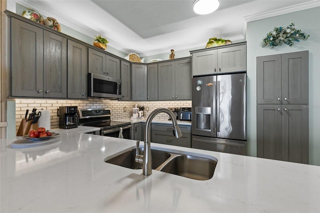 80 Surfview Dr Unit 721, Palm Coast, FL 32137 - kitchen featuring stainless steel appliances, decorative backsplash, crown molding, and light stone counters
