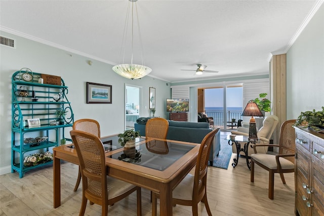80 Surfview Dr Unit 721, Palm Coast, FL 32137 - dining room featuring crown molding, light wood finished floors, and ceiling fan