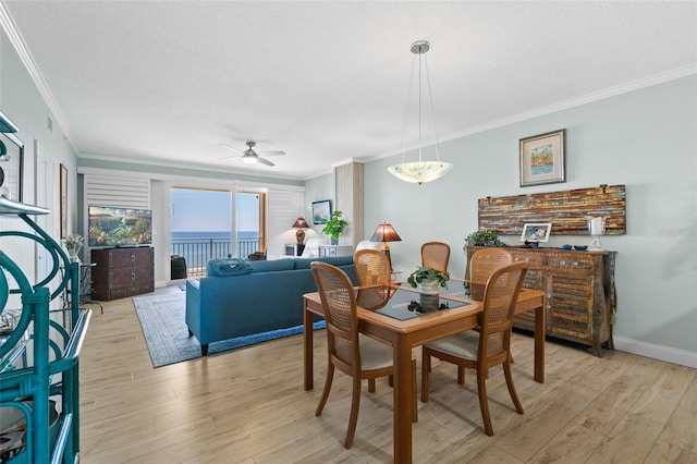 80 Surfview Dr Unit 721, Palm Coast, FL 32137 - dining space with crown molding, ceiling fan, and light wood-style flooring