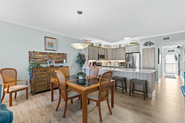 80 Surfview Dr Unit 721, Palm Coast, FL 32137 - dining room with ornamental molding and light wood finished floors