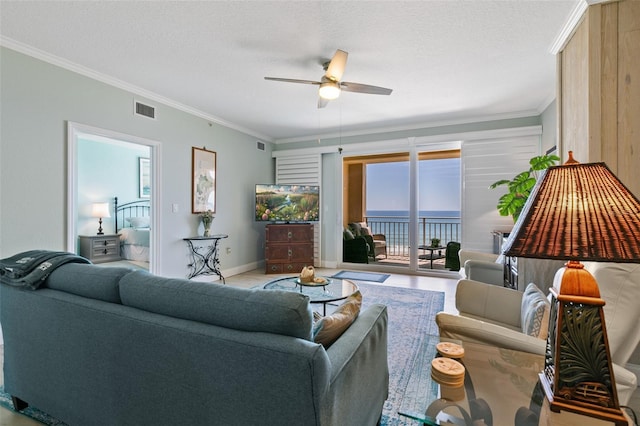 80 Surfview Dr Unit 721, Palm Coast, FL 32137 - living room with ornamental molding, ceiling fan, and a textured ceiling
